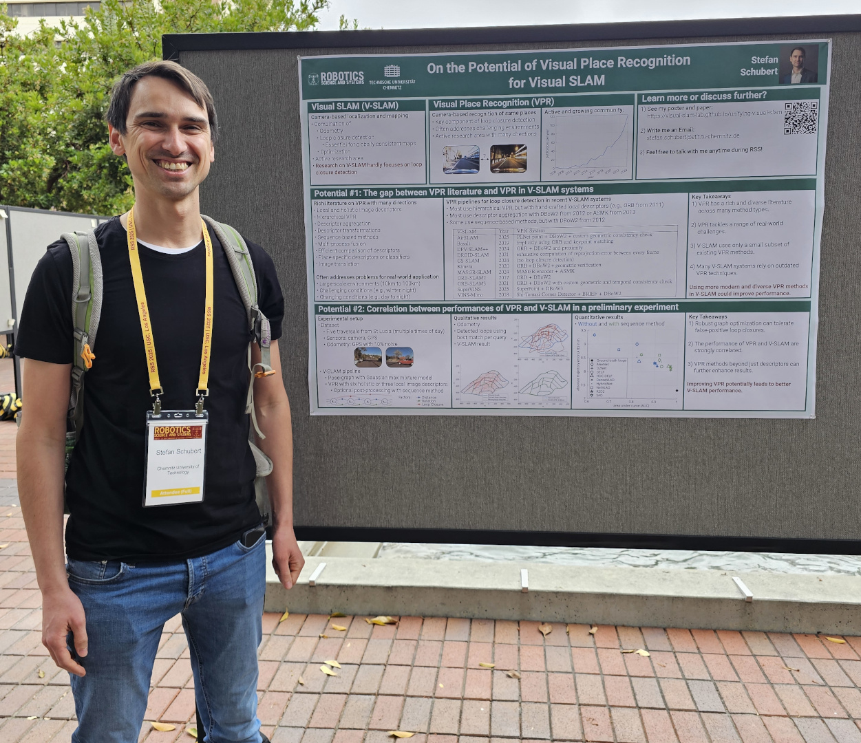 Photo of Dr. Stefan Schubert in front of his poster